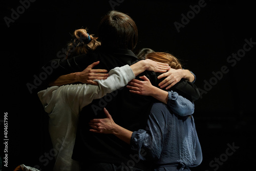 three people hug and hug each other, confirming the great friendship and bond between them