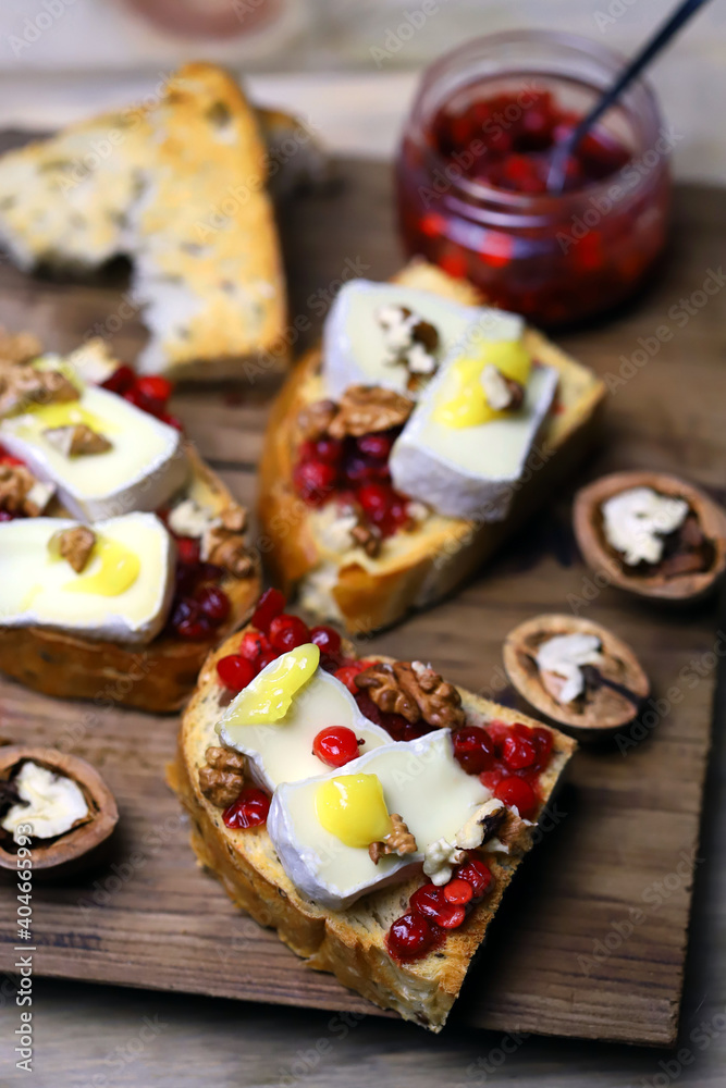 Bruschetta with brie cheese, jam, honey and nuts. Bruschetta with brie cheese, jam, honey and nuts.