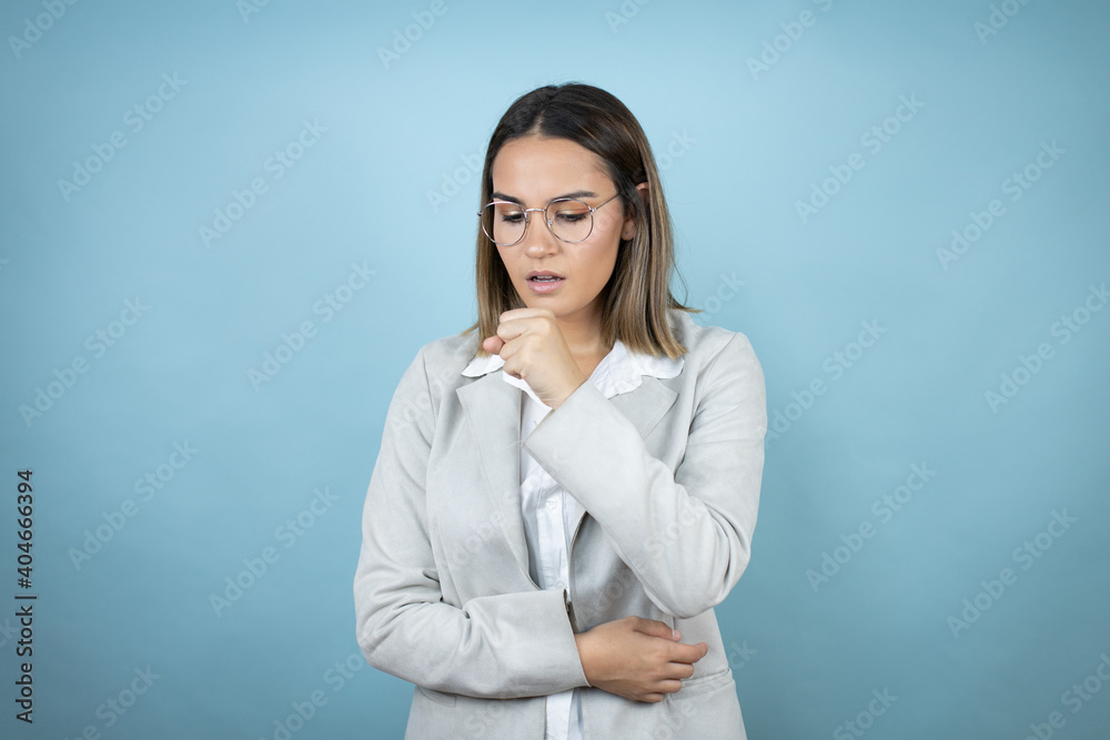 Young business woman over isolated blue background with her hand to her mouth coughing Young business woman over isolated blue background with her hand to her mouth coughing