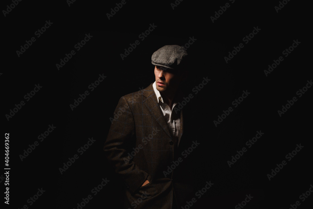 A man in a classic jacket and cap. A man in a classic jacket and cap.