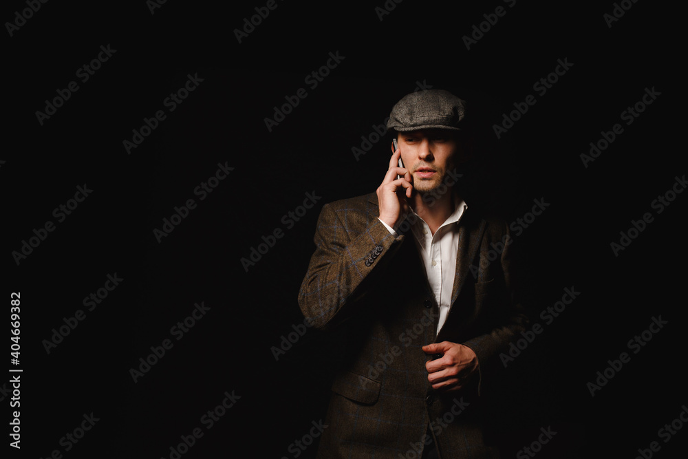 A man in a classic jacket and cap. A man in a classic jacket and cap.