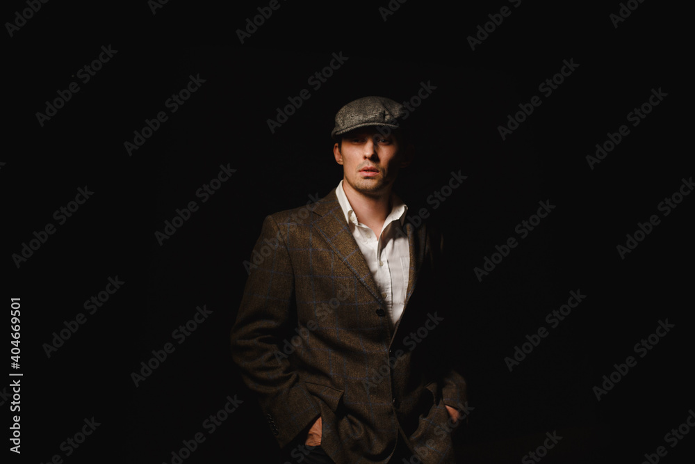 A man in a classic jacket and cap. A man in a classic jacket and cap.