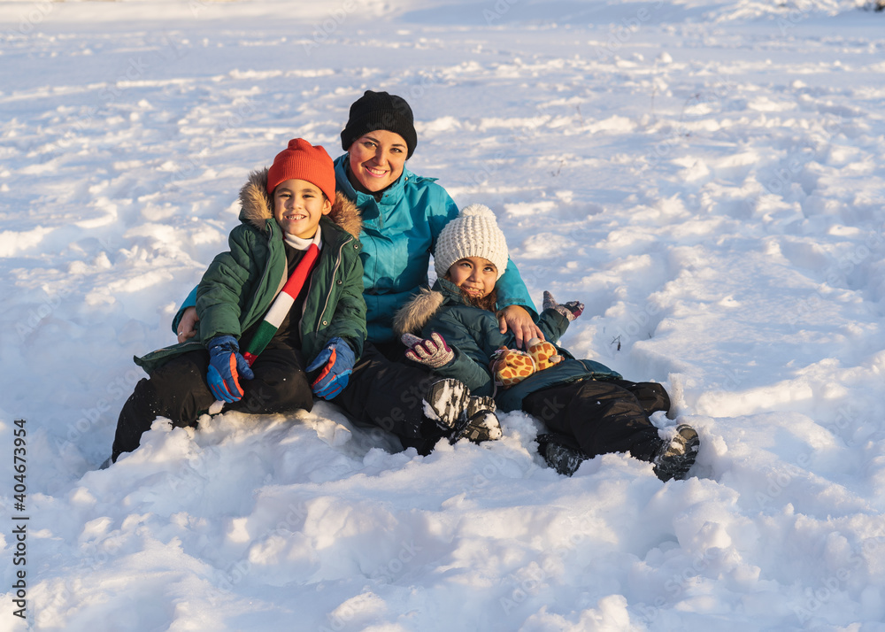 Happy loving family of Mother and children having fun, playing and laughing on sno Happy loving family of Mother and children having fun, playing and laughing on sno