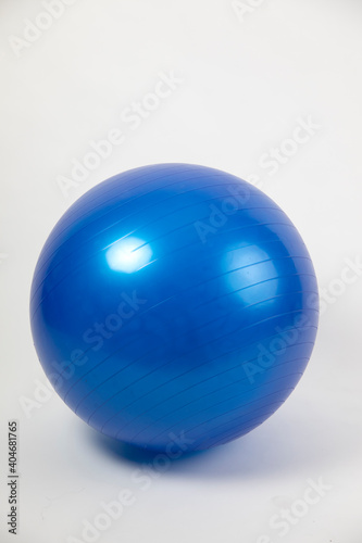 Blue birthing ball on white studio background with copy space. vertical format © Paul