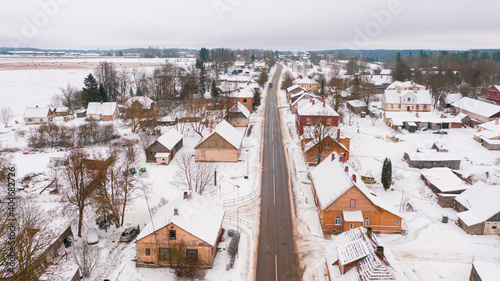 Akniste, Jekabpils, Latvia, Baltics.Beautiful panoramic aerial view photo from flying drone to Akniste city in winter.Beautiful winter view with snowy snow on small town fields and forests. (series) photo