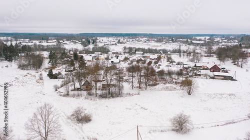 Akniste, Jekabpils, Latvia, Baltics.Beautiful panoramic aerial view photo from flying drone to Akniste city in winter.Beautiful winter view with snowy snow on small town fields and forests. (series) photo