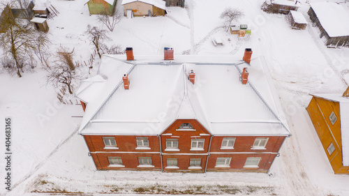 Akniste, Jekabpils, Latvia, Baltics.Beautiful panoramic aerial view photo from flying drone to Akniste city in winter.Beautiful winter view with snowy snow on small town fields and forests. (series) photo