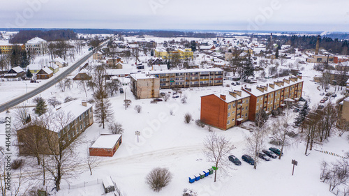 Akniste, Jekabpils, Latvia, Baltics.Beautiful panoramic aerial view photo from flying drone to Akniste city in winter.Beautiful winter view with snowy snow on small town fields and forests. (series) photo