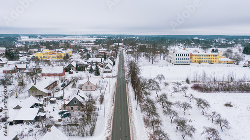 Akniste, Jekabpils, Latvia, Baltics.Beautiful panoramic aerial view photo from flying drone to Akniste city in winter.Beautiful winter view with snowy snow on small town fields and forests. (series) photo