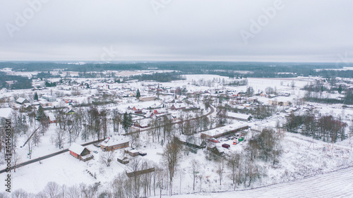 Akniste, Jekabpils, Latvia, Baltics.Beautiful panoramic aerial view photo from flying drone to Akniste city in winter.Beautiful winter view with snowy snow on small town fields and forests. (series) photo