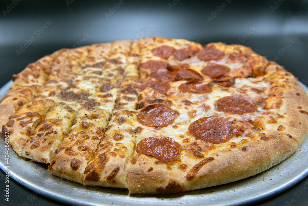Unique pizza is half bread sticks and half pepperoni and cheese pizza, Unique pizza is half bread sticks and half pepperoni and cheese pizza,