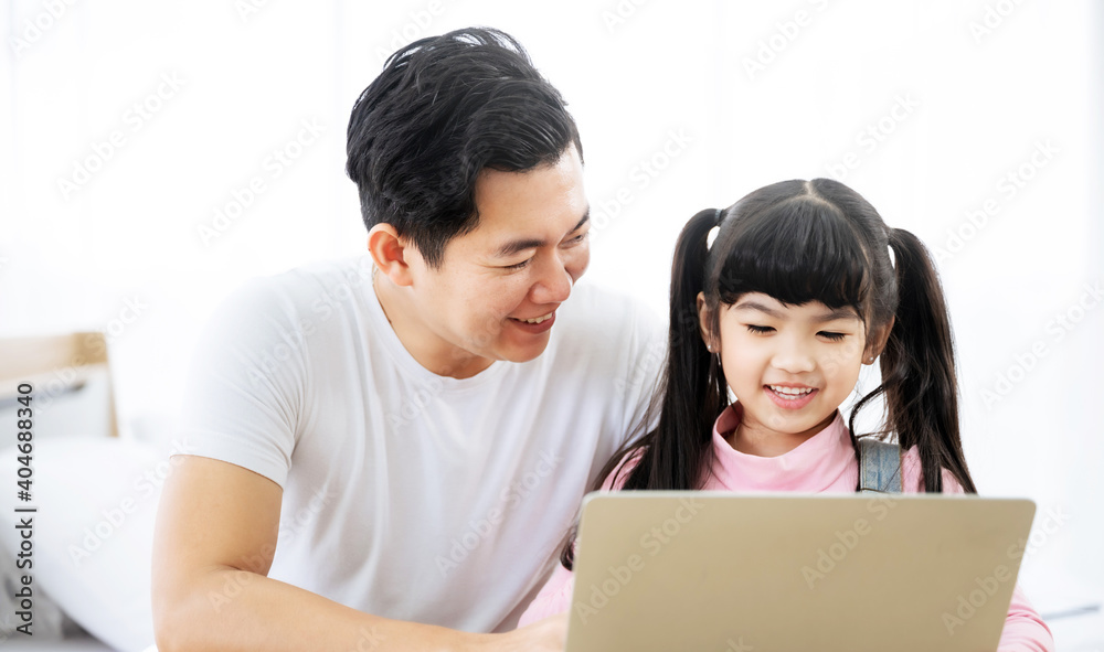 Father and daughter learning education study online class. Kid girl and dad using computer laptop at home