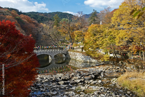 A picturesque arched bridge crosses Taegeukcheon Stream to access the Magoksa Buddhist temple complex, Gongju, South Korea. photo