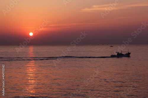 Ship silhouette with sunrise on the sea