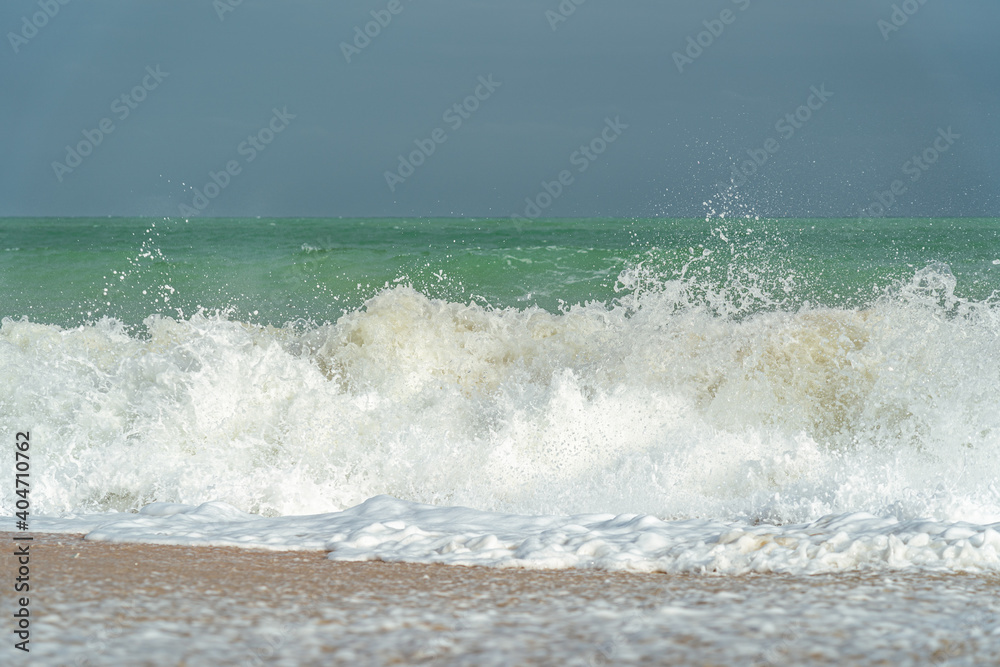 Fototapeta premium Big waves and surf on a sandy tropical beach