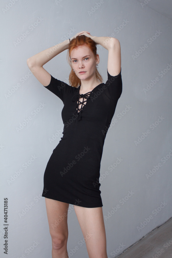 portrait of a red hair woman in short black dress portrait of a red hair woman in short black dress