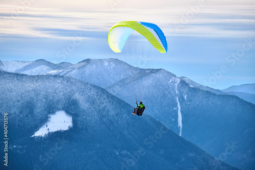 Paraglading in winter by mountains. Paraglide in the air. Vancouver. British Columbia. Canada 