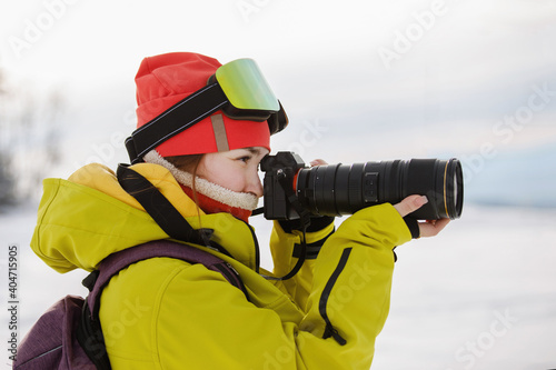 Photographer in the open air in winter ski clothes
