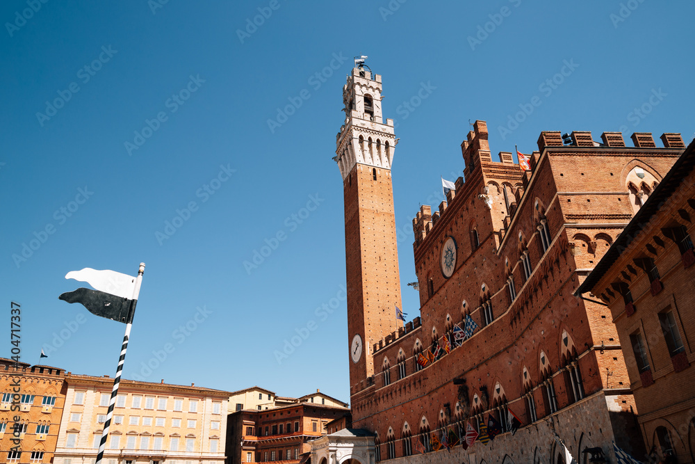 Fototapeta premium Torre del Mangia tower at Campo square in Siena, Italy