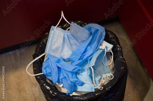 Medical masks are thrown in the trash.