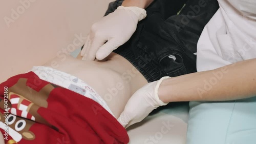 Pediatrician doing checkup on young boy.