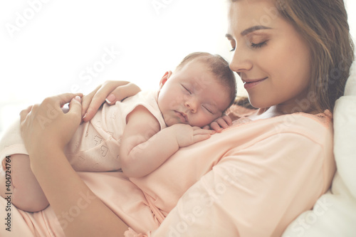 Portrait of a beautiful mother, with her nursing baby. High quality photo.