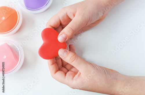 The child holds a heart made with his own hands from plasticine. The concept of love. Copy space.