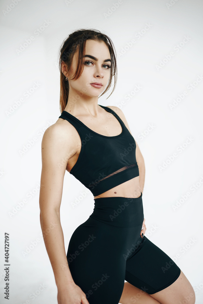 beautiful young girl is engaged in fitness. sports lifestyle. White background beautiful young girl is engaged in fitness. sports lifestyle. White background