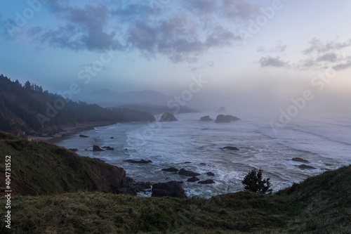 Soft colors of foggy winter sunset over Ecola State Park in Oregon © Victoria