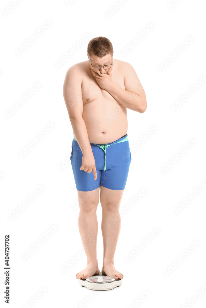 Stressed overweight man with scales on white background. Weight loss concept