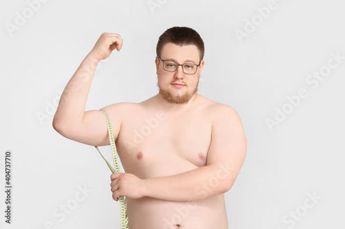 Overweight man with measuri...