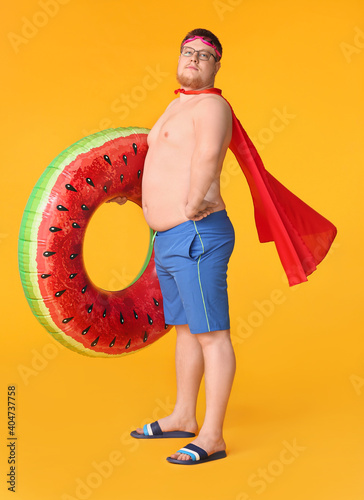 Overweight man in cape and ...