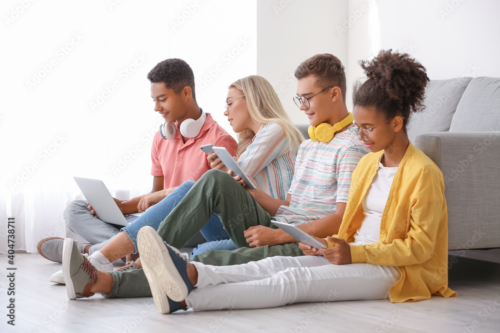 Teenagers with different devices at home Teenagers with different devices at home