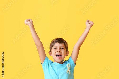 Little boy with golden ribb...