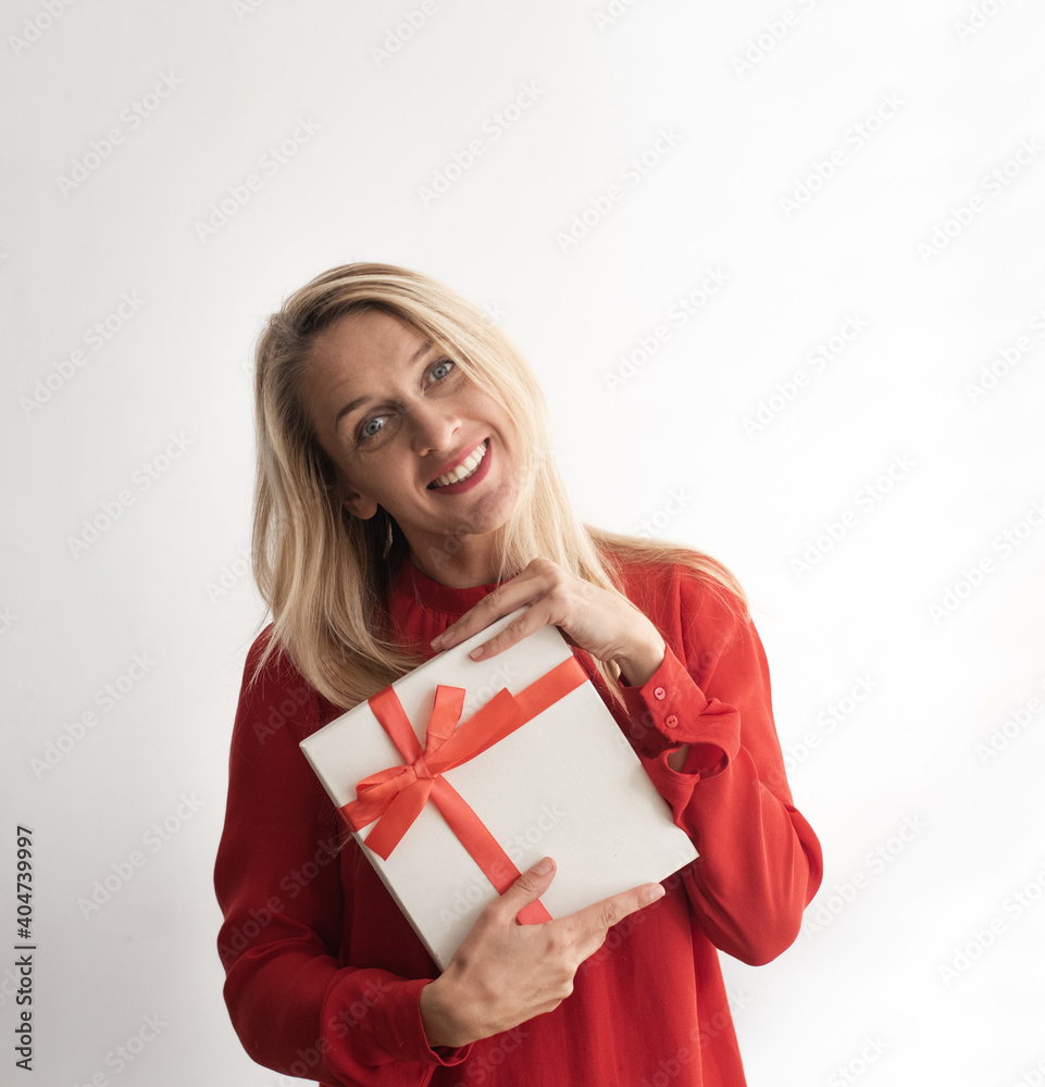 Young woman holds white gift box and thinking what inside. Person very pensive face look away. Girl wearing red blouse on white background. Gift on Lovely Valentine's Day or celebration birtday. Young woman holds white gift box and thinking what inside. Person very pensive face look away. Girl wearing red blouse on white background. Gift on Lovely Valentine's Day or celebration birtday.