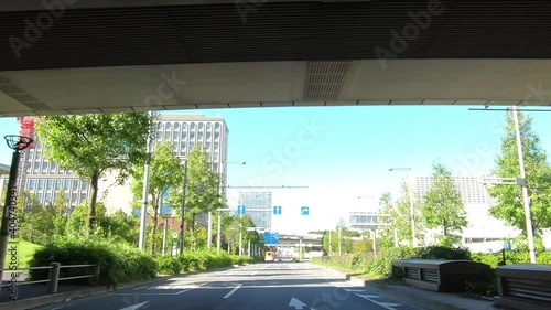 Japanese cityscape. Roadside trees and straight roads