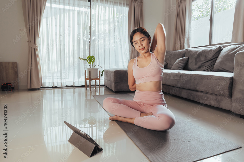 Young woman stretching after exercise at home. Fit woman workout at home. Home exercise. Young woman stretching after exercise at home. Fit woman workout at home. Home exercise.