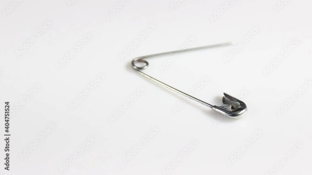 Sewing pin on a white background. Turntable. Selective shot.