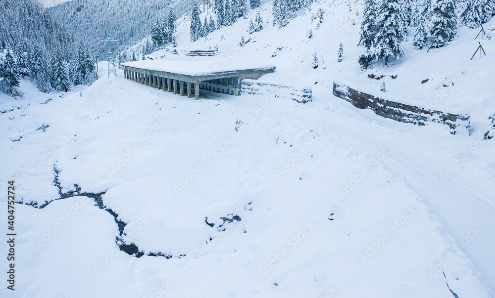 Aerial drone view of the amazing curved windy road motorway Transfagarasan in Romania during a winter morning landscape with mountains in background Aerial drone view of the amazing curved windy road motorway Transfagarasan in Romania during a winter morning landscape with mountains in background