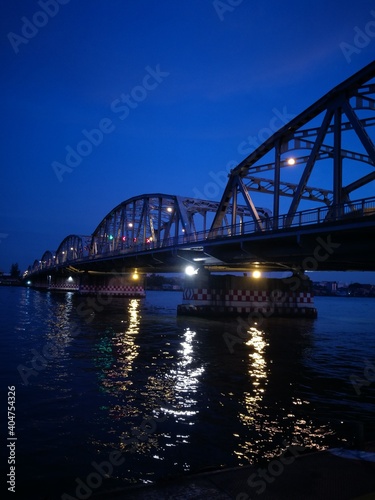 Illuminated Bridge Over River At Night #404754326