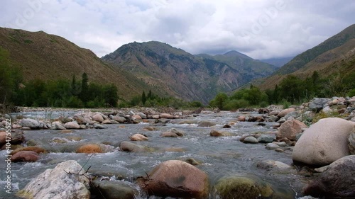 River with mountain torrent and many rocks. Wild nature landscape. Adventure tourism. Tough nature concept. Usek river gorge in Kazakhstan. Nature of Kazakhstan, tourism concept. photo