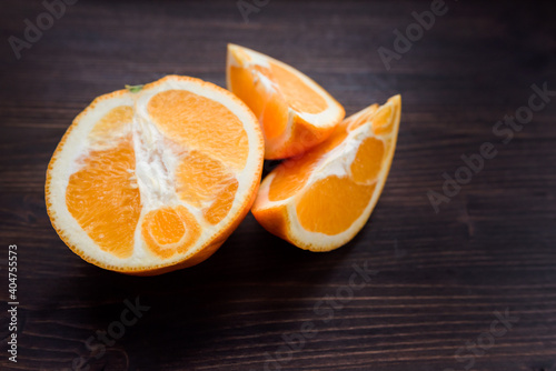 sliced orange on a dark wooden table