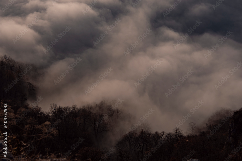 Beautiful white clouds over the mountains. Mountain landscape. Forest and mountains.