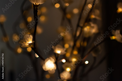 Focus on a electrical flower shaped light garland on a brown background