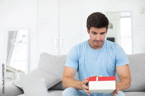 Man with a gift in his hands at home.