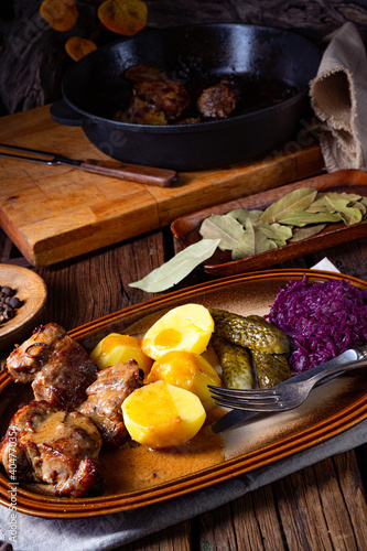 Rustic Snirtjebraten with red cabbage and cucumber photo