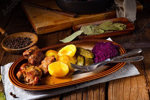 Rustic Snirtjebraten with red cabbage and cucumber photo