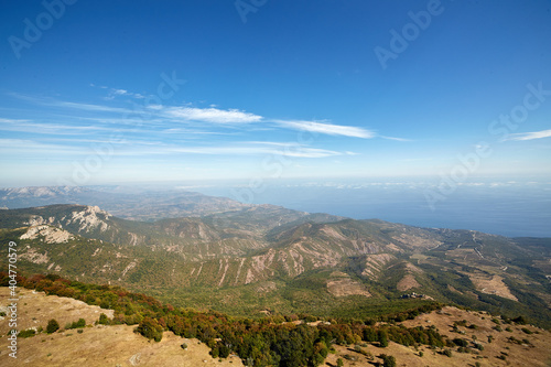 view of the coast with the sea and mountains against the blue sky from a bird's eye view (ID: 404770579)