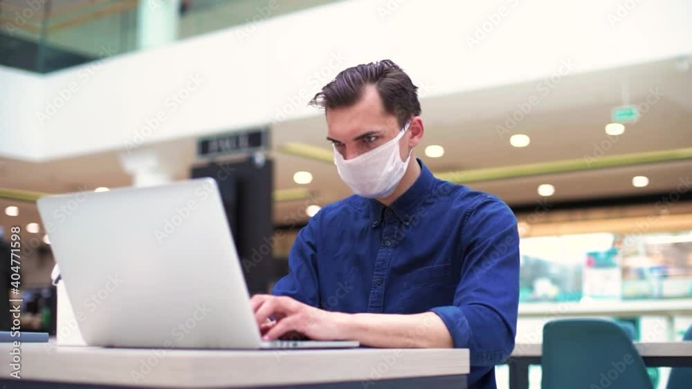 young man is working on a laptop in a cozy cafe. young man is working on a laptop in a cozy cafe.