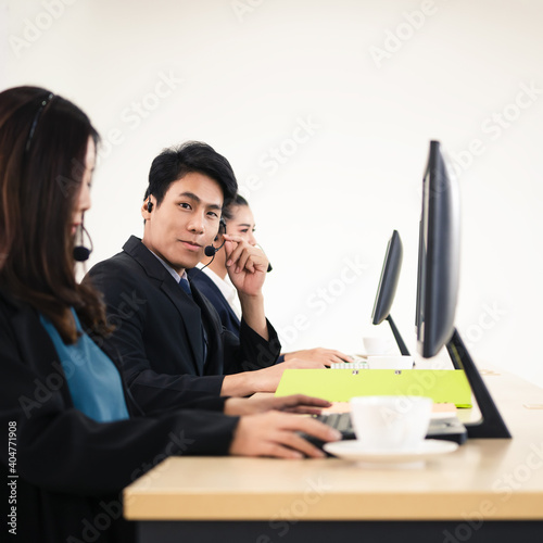 Business staff asian man using headphone and computer for call center